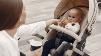 mum-sitting-bench-woman-pushing-her-toddler-sitting-pram-family-concept1-352x198.jpg